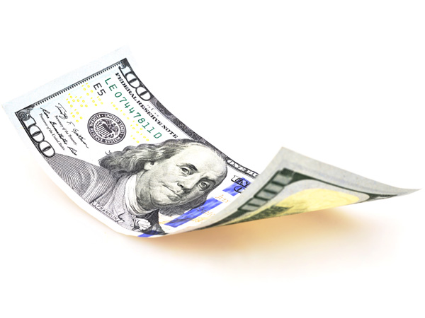 Slightly curled $100 bill showing Benjamin Franklin's face