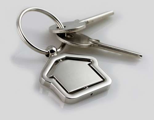 Keys on a chrome ring with a chrome, house-shaped key fob